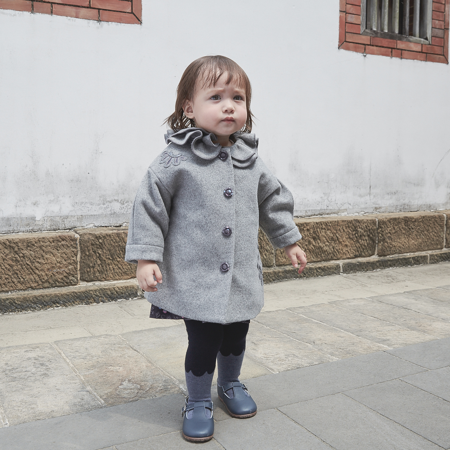 Heather grey baby coat with moonflower motif