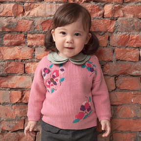 Pine green baby top with embroidered pomegranate motif