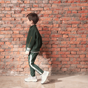 Dark green kids trousers with YUAN logo ribbons