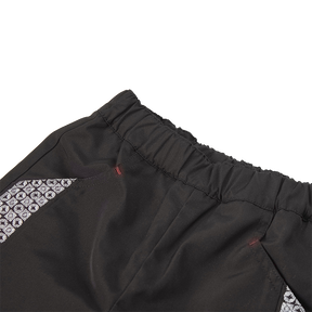 Black kids trousers with geometric designs