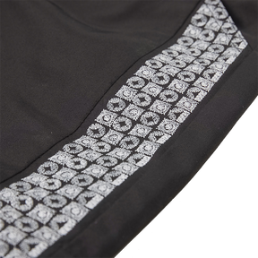 Black kids trousers with geometric designs