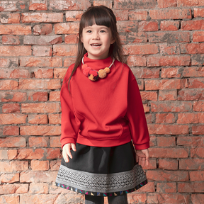 Red kids top with pom pom necklace