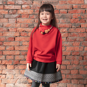 Red kids top with pom pom necklace