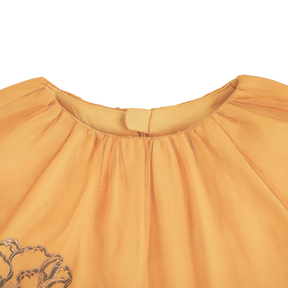 Mustard kids bubble top with gauze overlay and peony motif